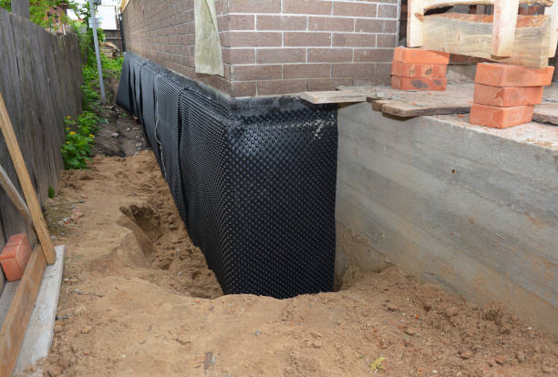 Happy homeowners after waterproofing job in North Collins